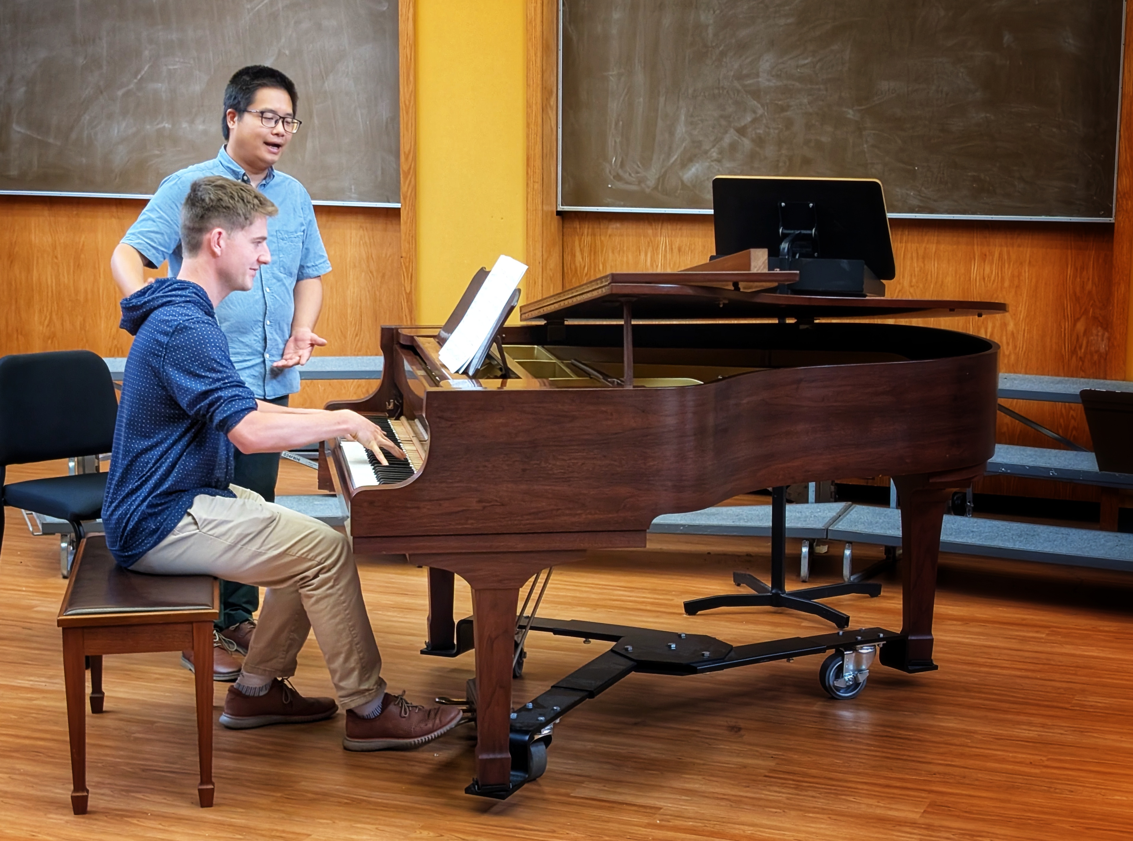 Nanyi giving piano instruction to a student